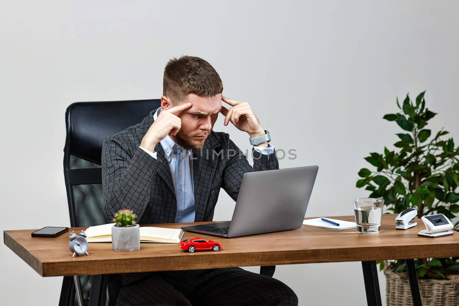Exhausted tired man using laptop pc computer finding problem solving solutions