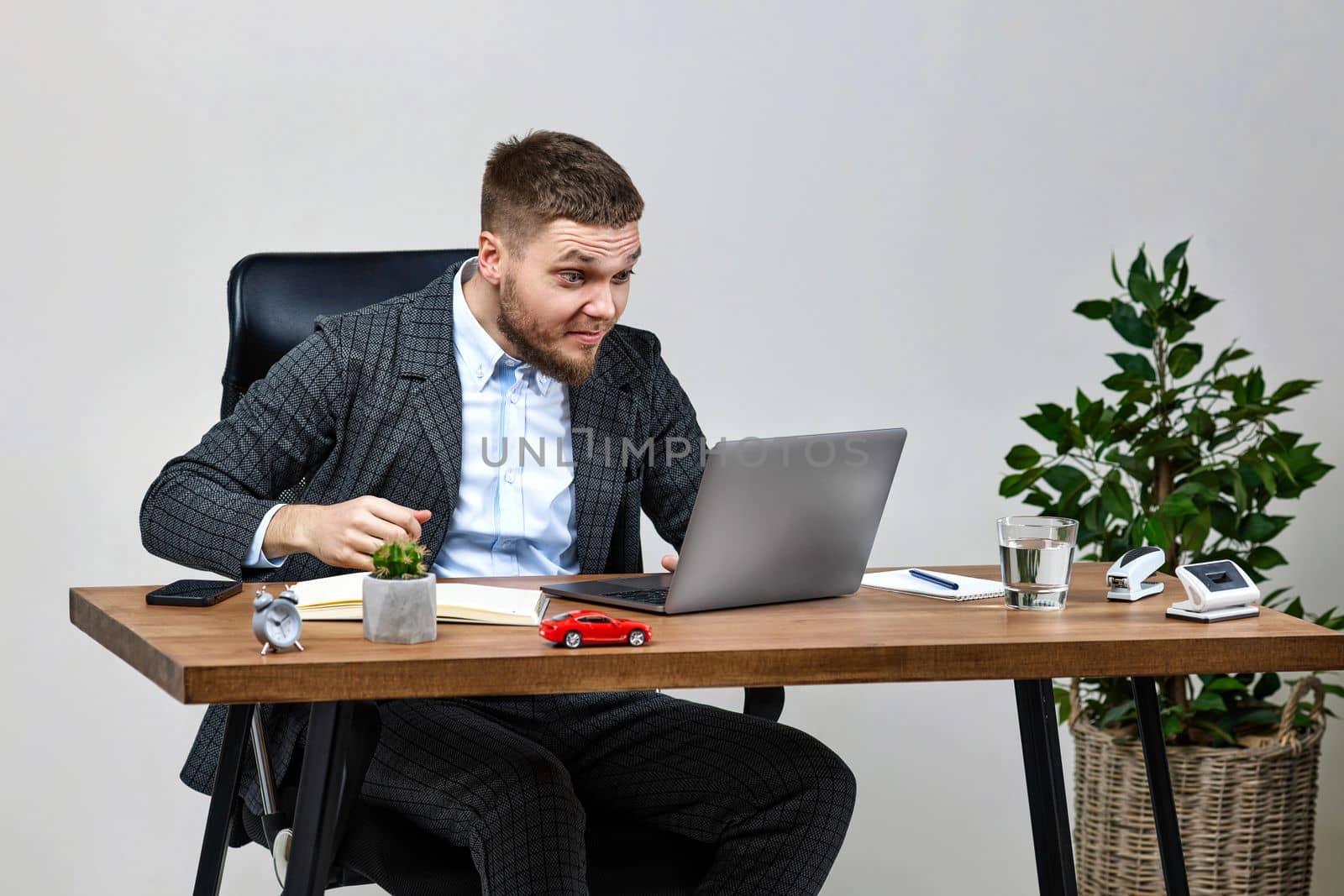 man sitting on chair at table and resting, using laptop by erstudio