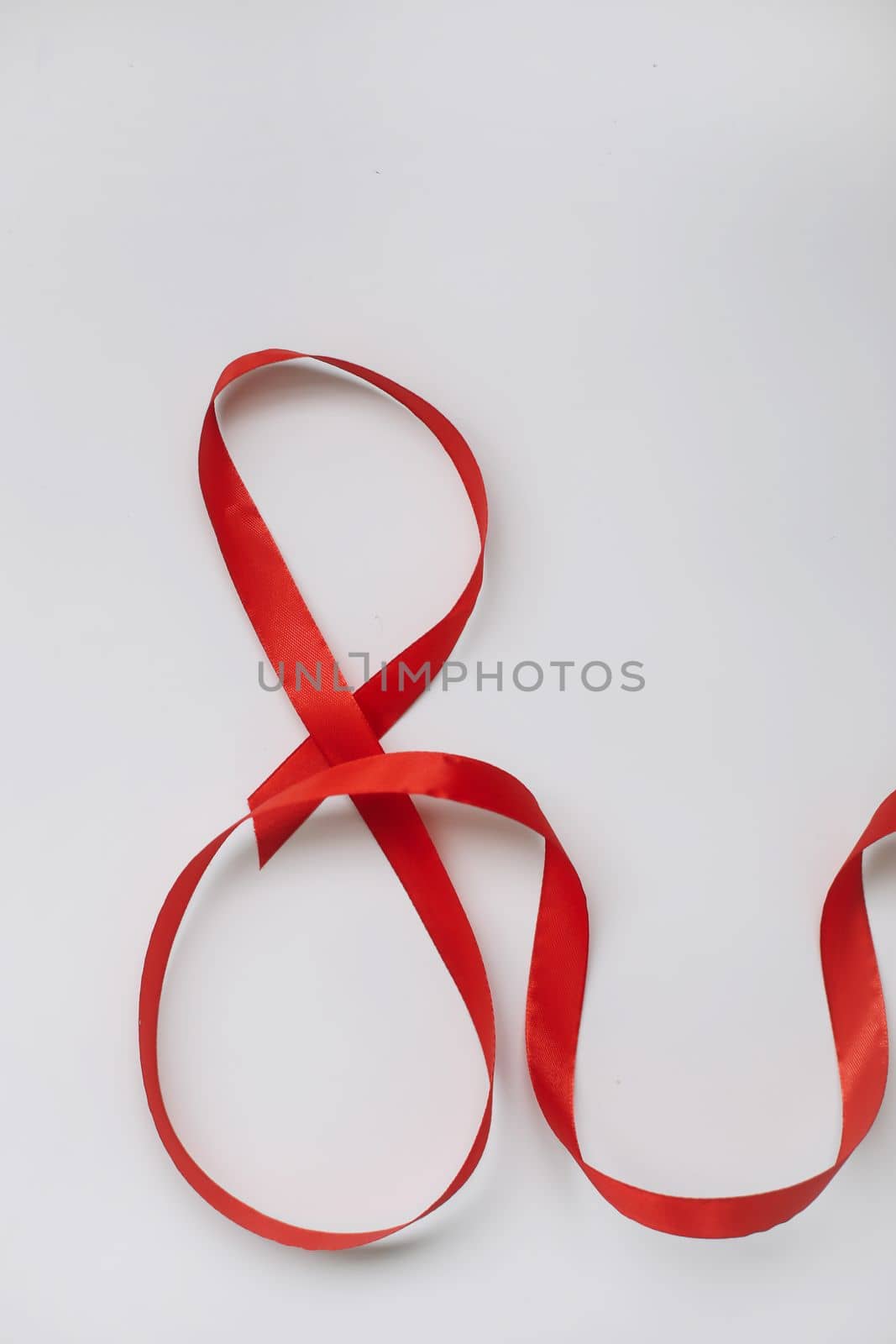 Eight made of red ribbon. 8 March greeting card template. International Women's day background, banner, poster