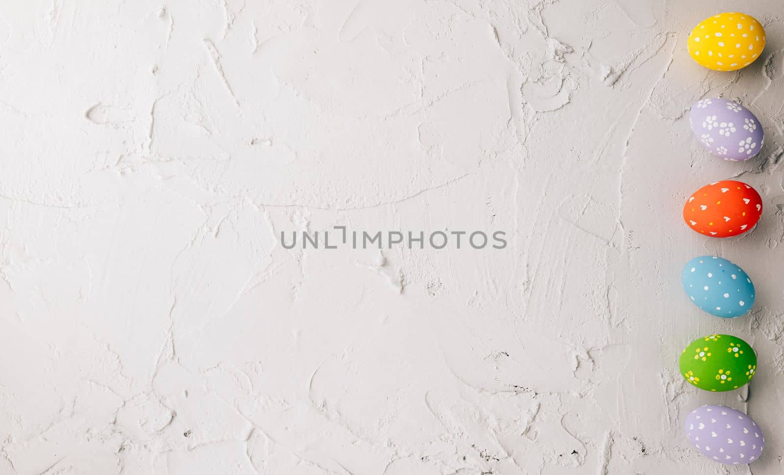 Happy Easter Day Concept. Top view holiday banner background web design white colorful easter eggs painted on cement background with empty copy space, celebration greeting card, overhead, template