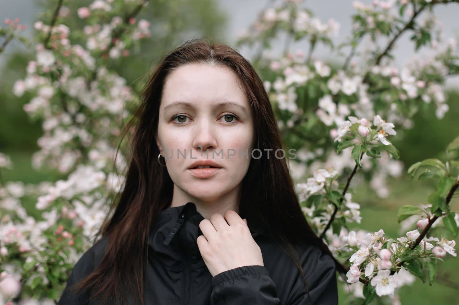 Beautiful young woman near blooming spring tree. Youth, love, fashion, romantic and lifestyle concept