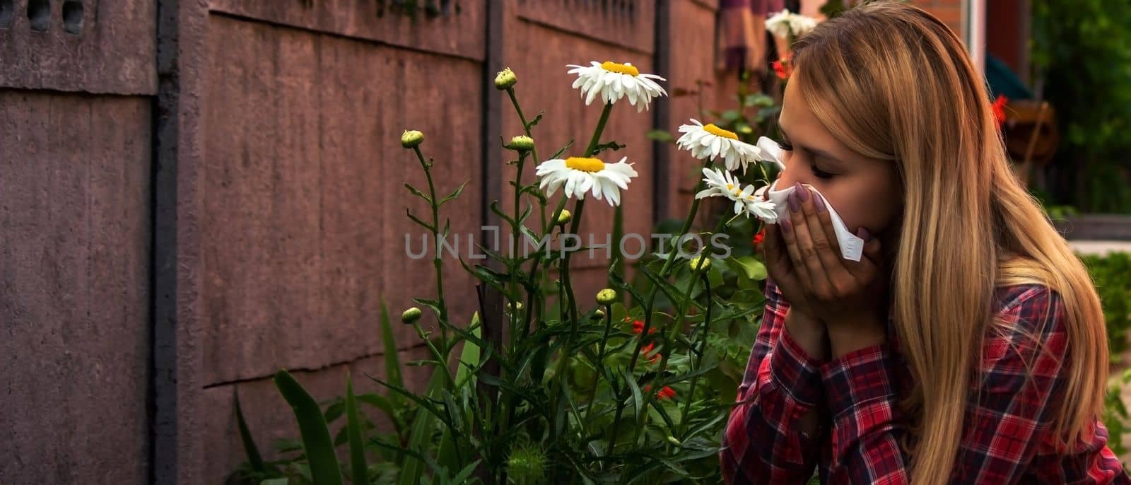 A young woman is allergic to flowers. Selective focus