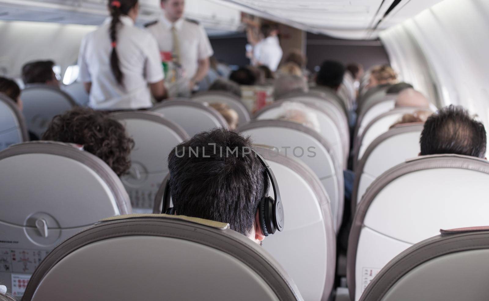 Interior of airplane with passengers on seats