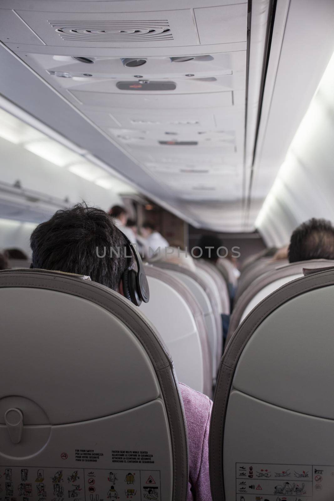 Interior of airplane with passengers on seats