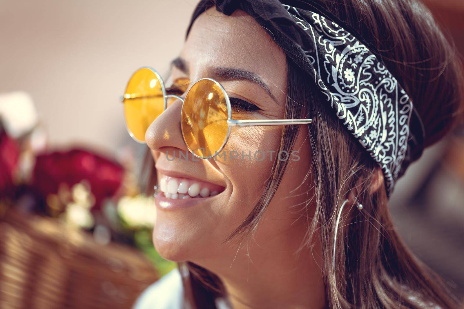 Portrait of a happy smiling young woman with sunglasses who is enjoying in a summer sunny day.
