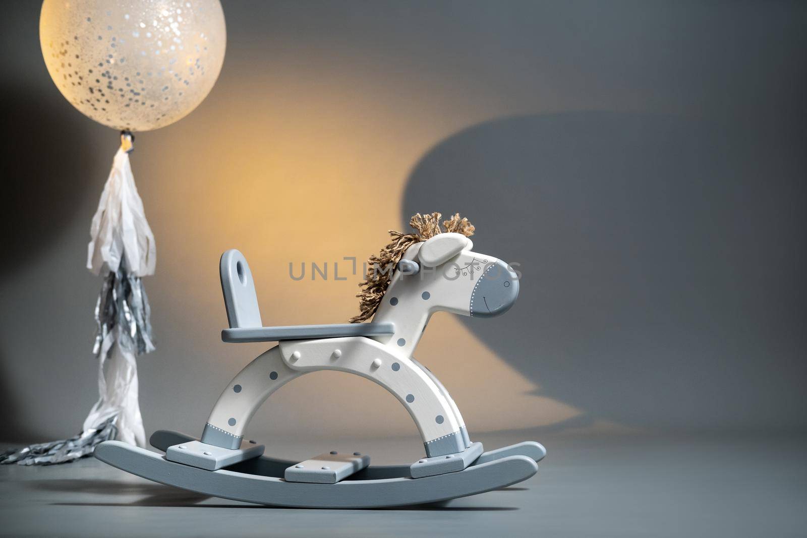 Handmade rocking horse on a gray background.
