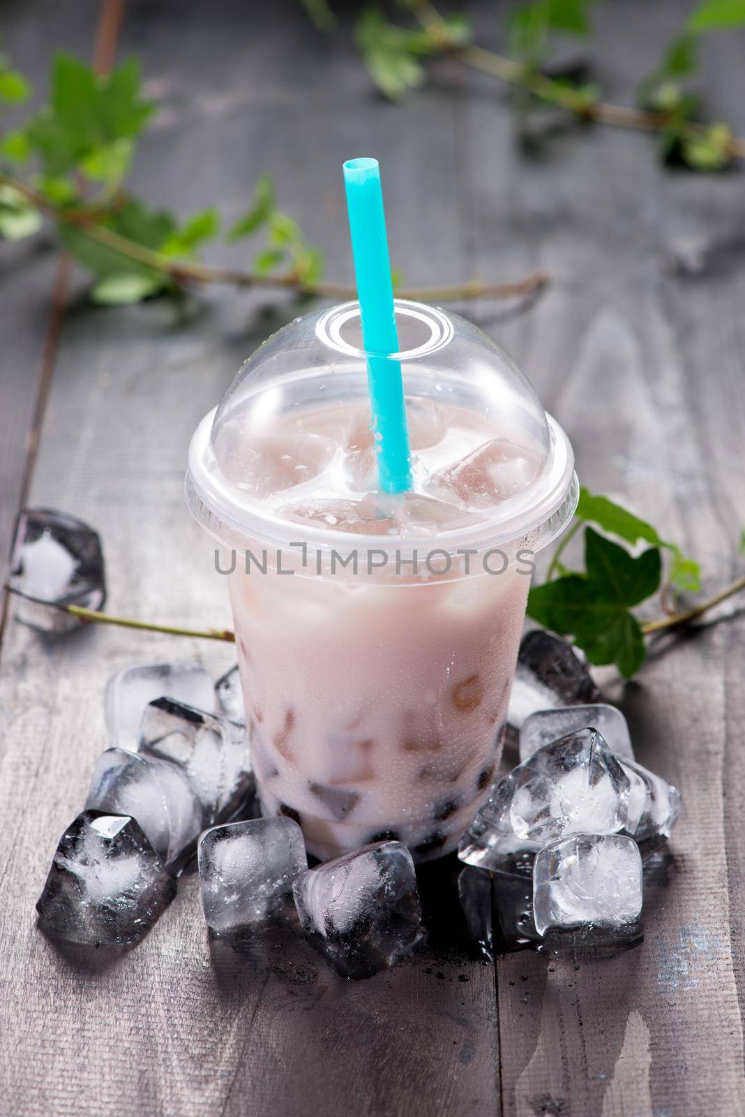 Taro bubble tea and black tapioca pearls on crushed ice by makidotvn