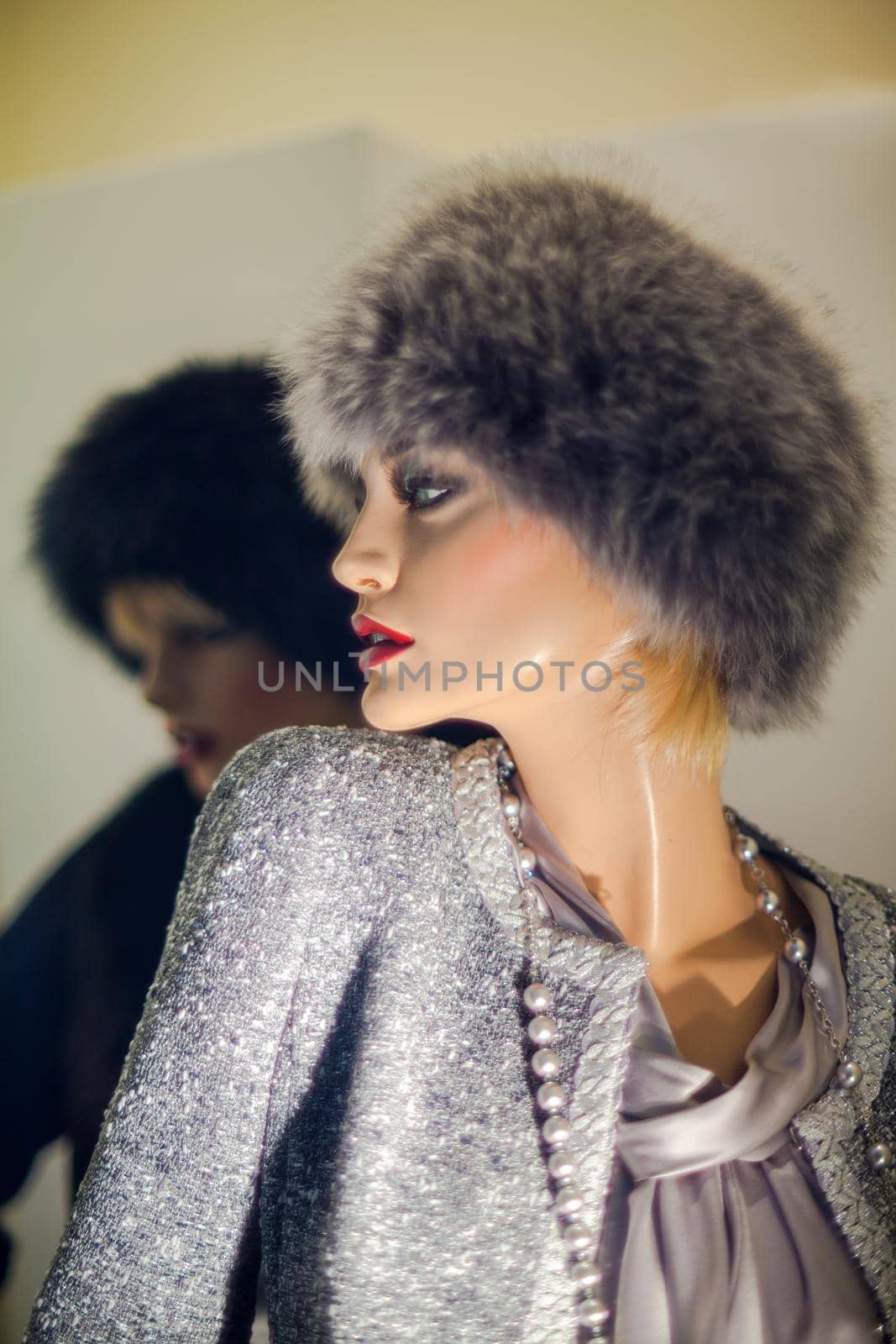 Female mannequin with fur hat in the boutique