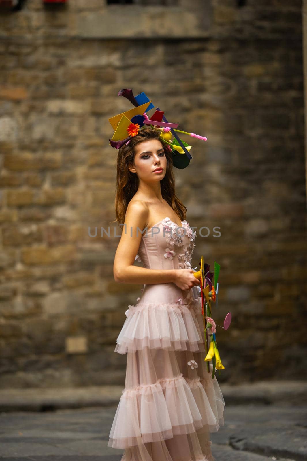 a bride in a pink wedding dress with an unusual bouquet and decoration in Gorova in Florence, Italy by Lobachad