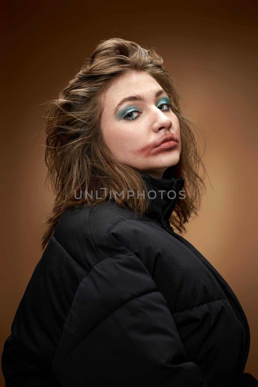 portrait of woman with smudged lipstick and in black jacket on beige background. by erstudio
