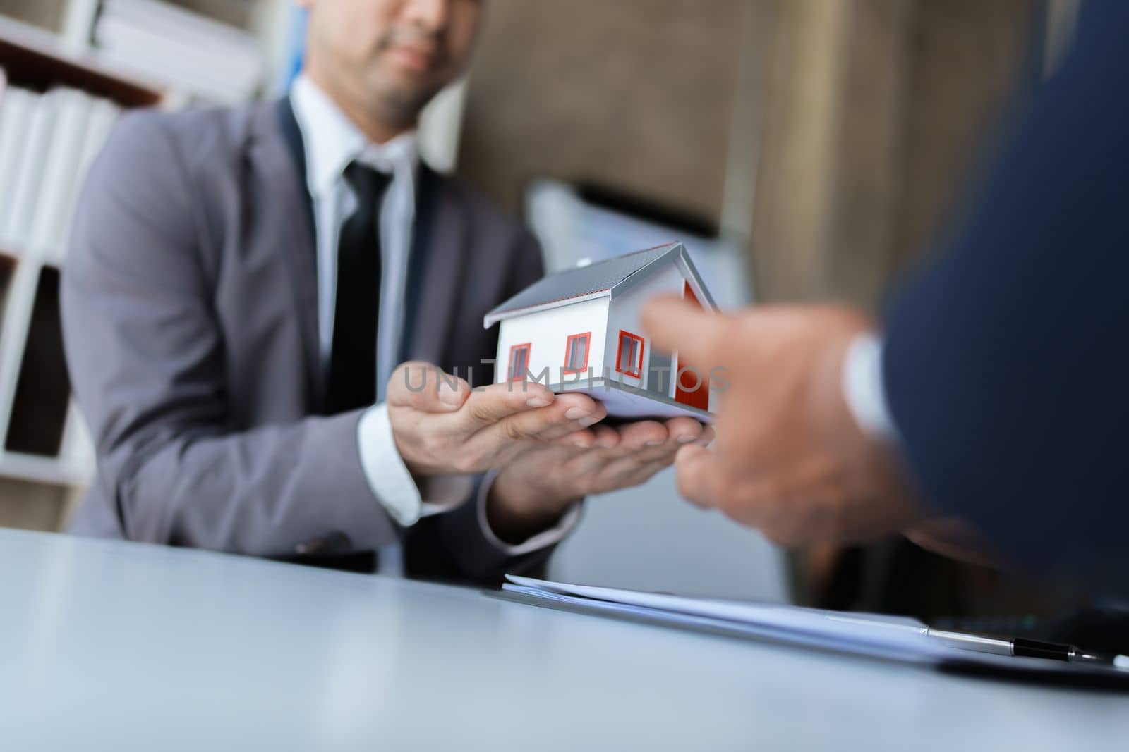 Real estate company to buy houses and land are delivering keys and houses to customers after agreeing to make a home purchase agreement and make a loan agreement. by Manastrong