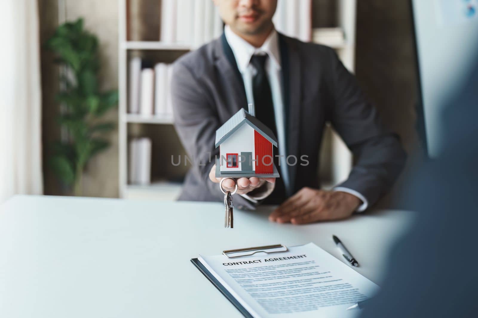 Real estate company to buy houses and land are delivering keys and houses to customers after agreeing to make a home purchase agreement and make a loan agreement. by Manastrong