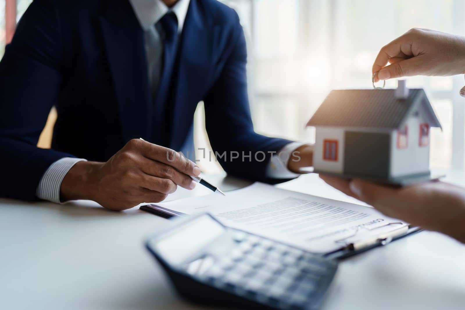 Real estate company to buy houses and land are delivering keys and houses to customers after agreeing to make a home purchase agreement and make a loan agreement. by Manastrong