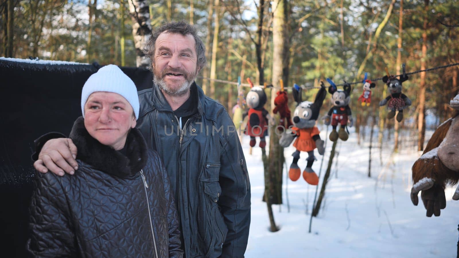 A homeless man and woman giving an interview in the winter in the woods. by DovidPro