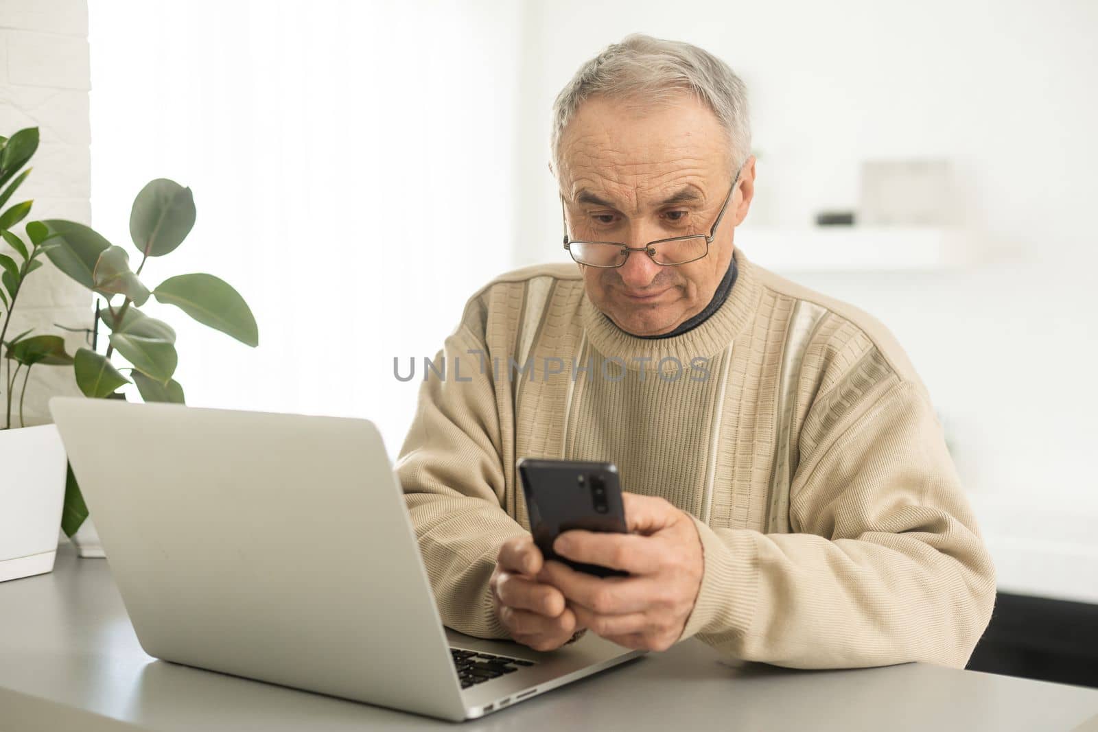 Busy smart mature professional man using laptop sitting. Middle aged older adult businessman, senior entrepreneur of mid age remote working or learning online typing on computer