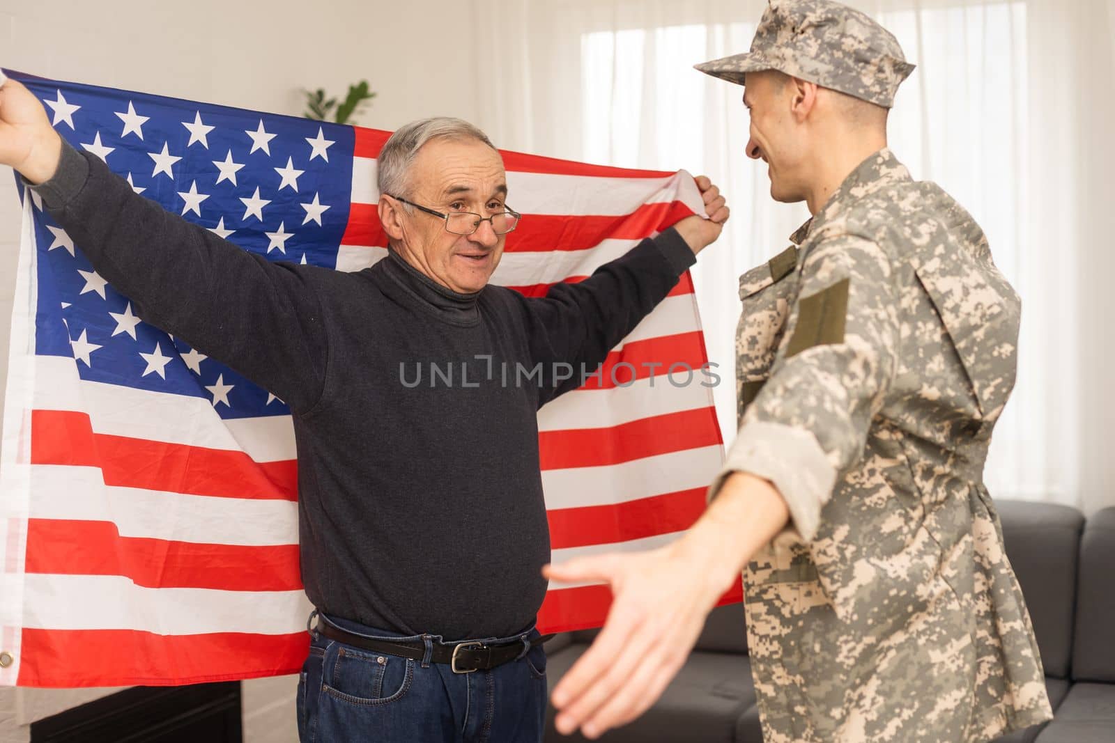 an elderly father and a military son saluting American flag by Andelov13