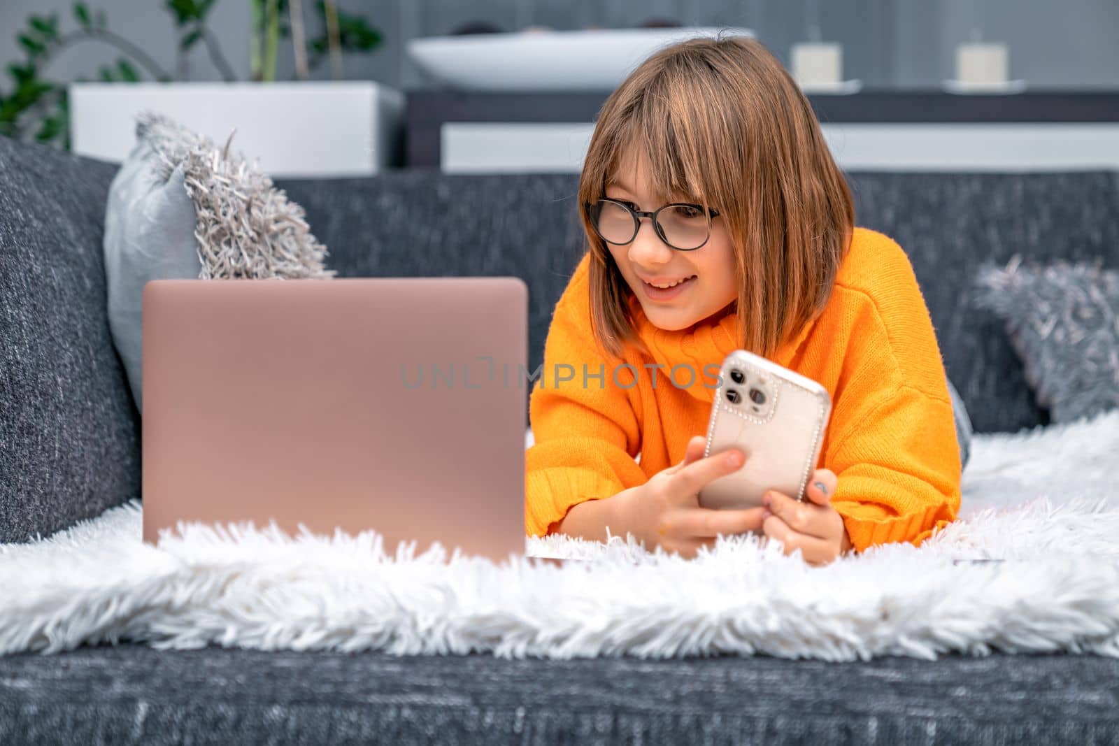 child rejoices success in front of laptop screen. High quality photo
