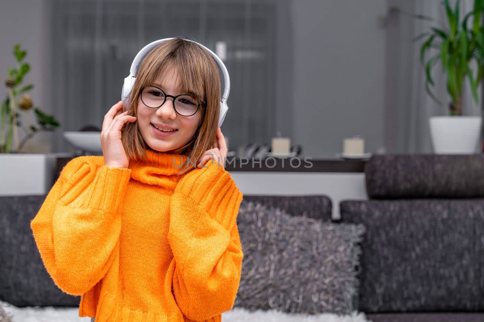 child listens to music in wireless headphones.