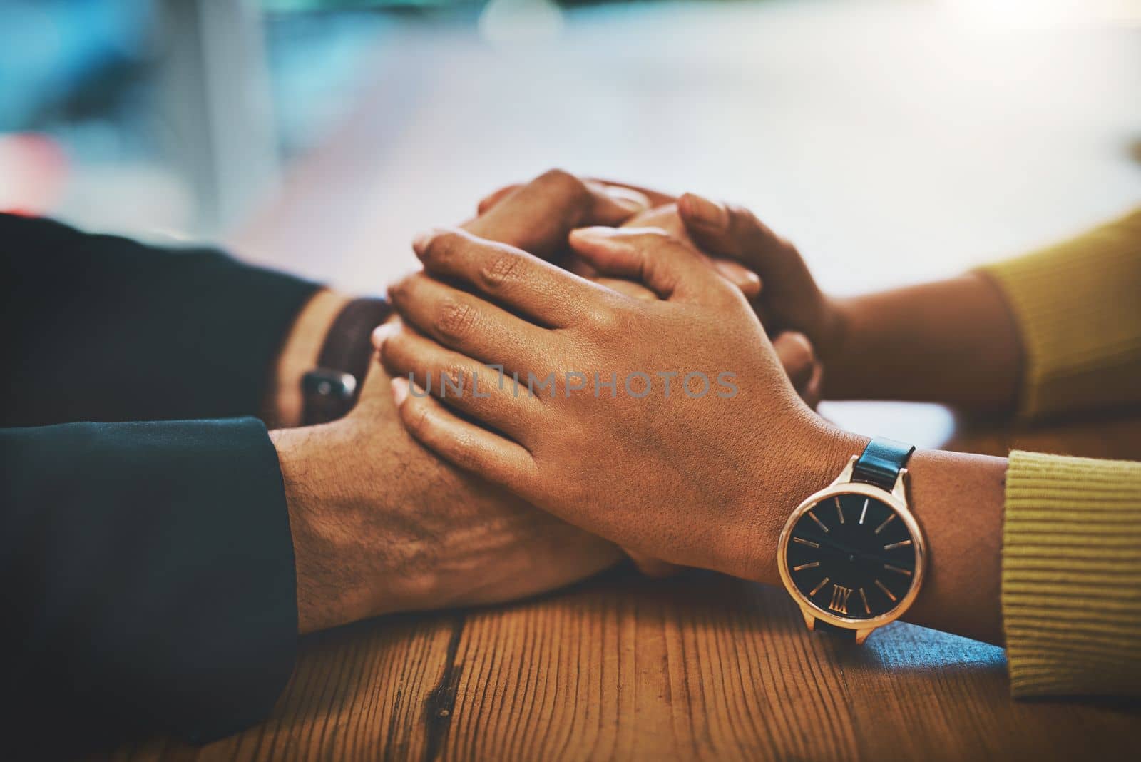 Ive got you and youve got me. a man and woman compassionately holding hands at a table