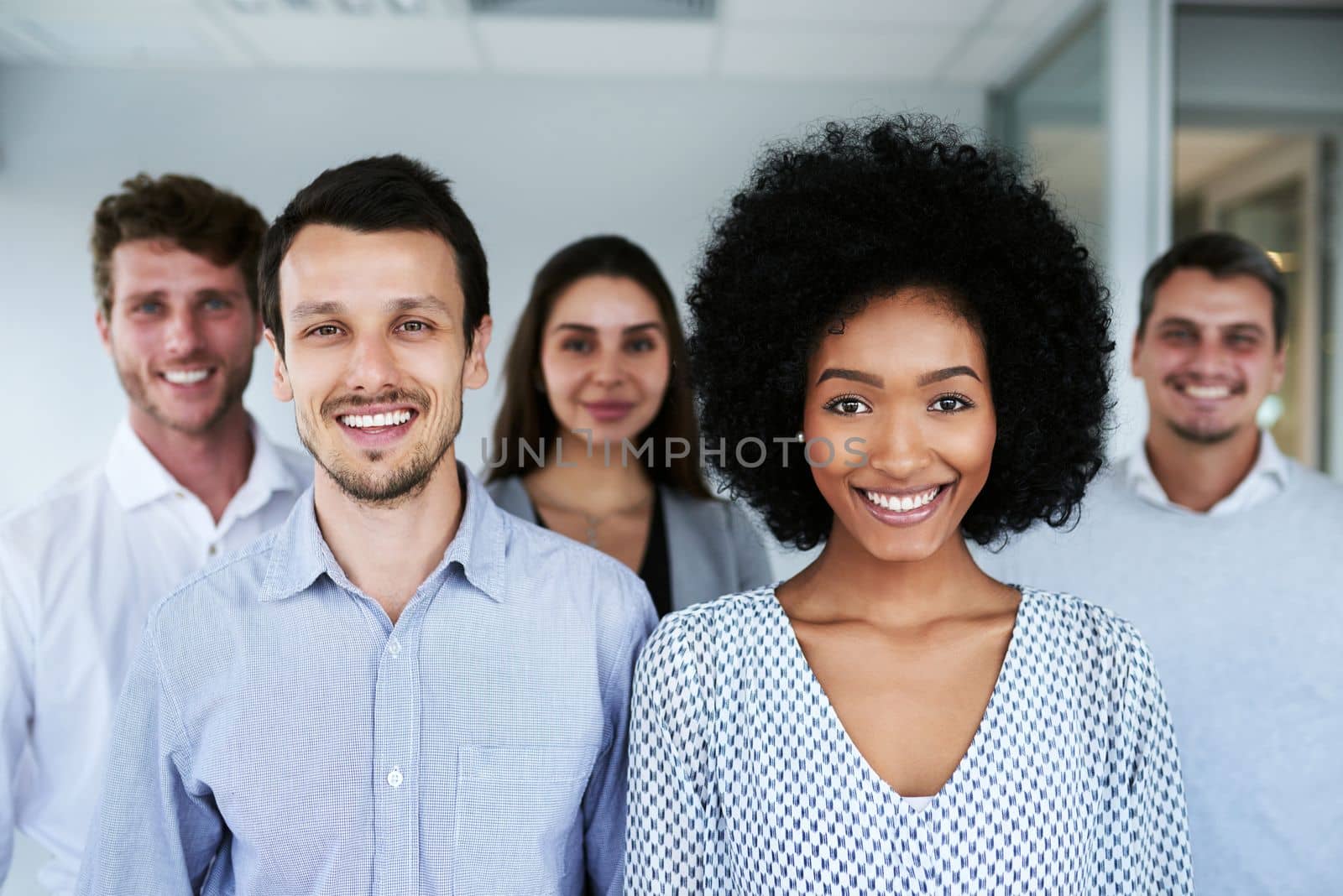 Were here to achieve our best. Portrait of a group of businesspeople standing together in an office