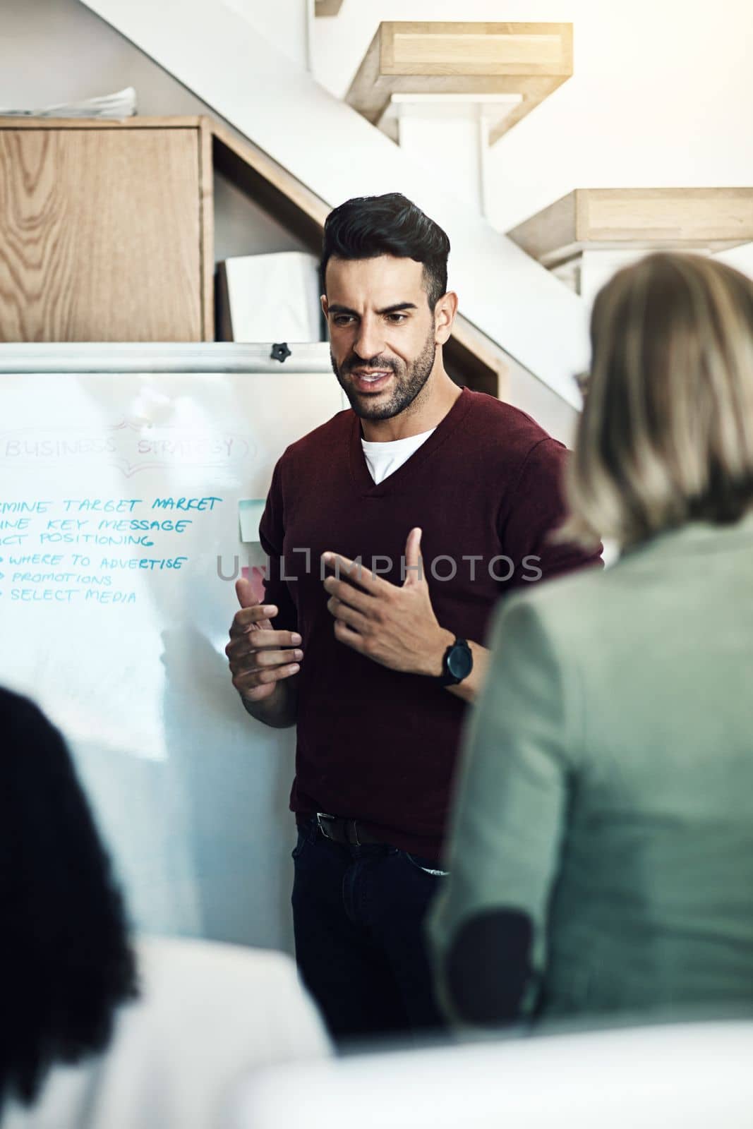 He knows how to keep them interested. a group of colleagues having a brainstorming session in a modern office