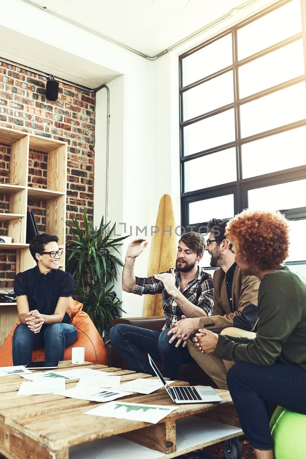 Be clear about what you want to grow. a group of young designers having a discussion in a modern office. by YuriArcurs