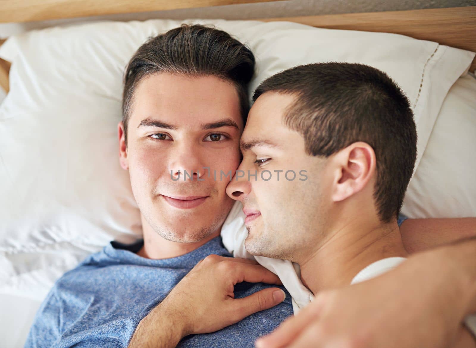 I never want to get up. Portrait of a young gay couple relaxing in bed. by YuriArcurs