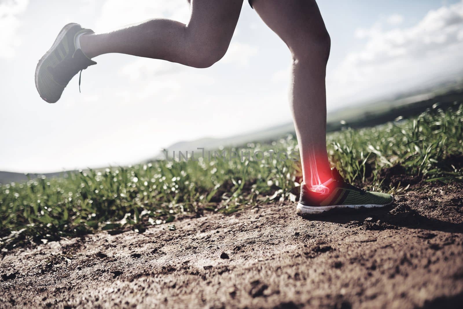 The ankle joint is taking some strain. an unrecognizable man running with an injury highlighted by cgi