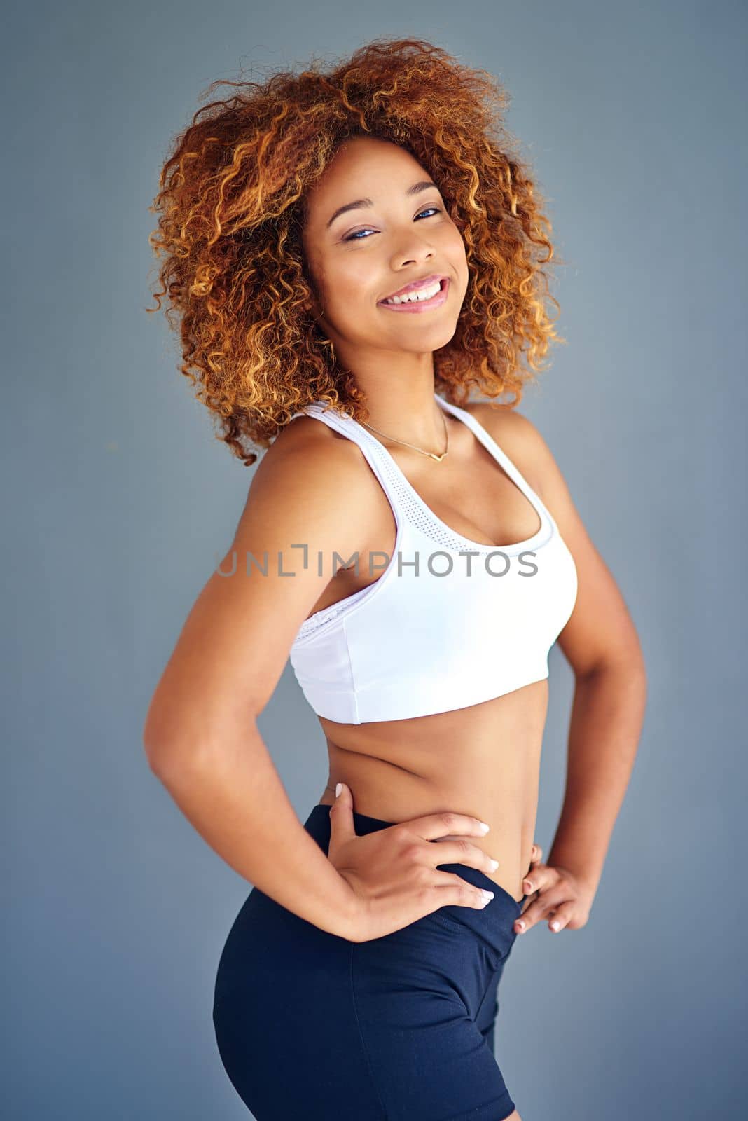 Today is another chance to make yourself proud. a sporty young woman posing against a grey background
