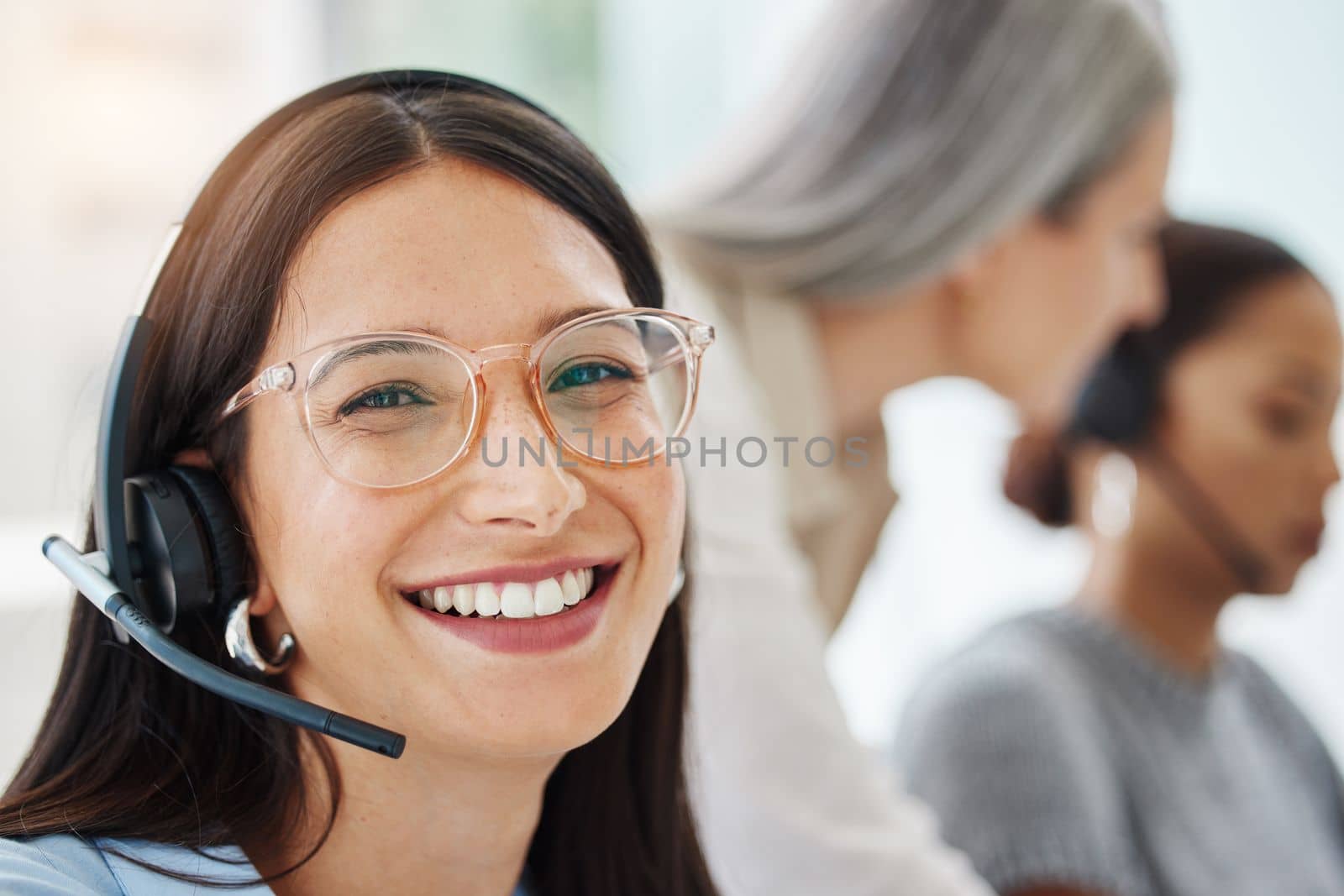 This job never ceases to make me smile. an attractive young saleswoman sitting in the office and wearing a headset