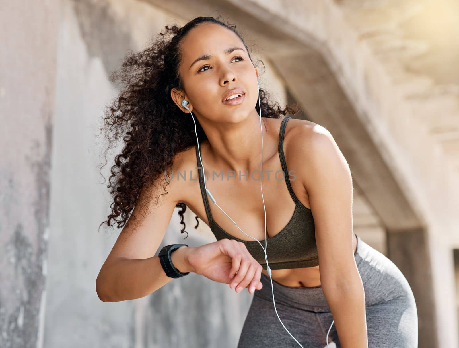 That felt a lot faster than I thought. an attractive young woman looking contemplative while checking her watch during her outdoor workout