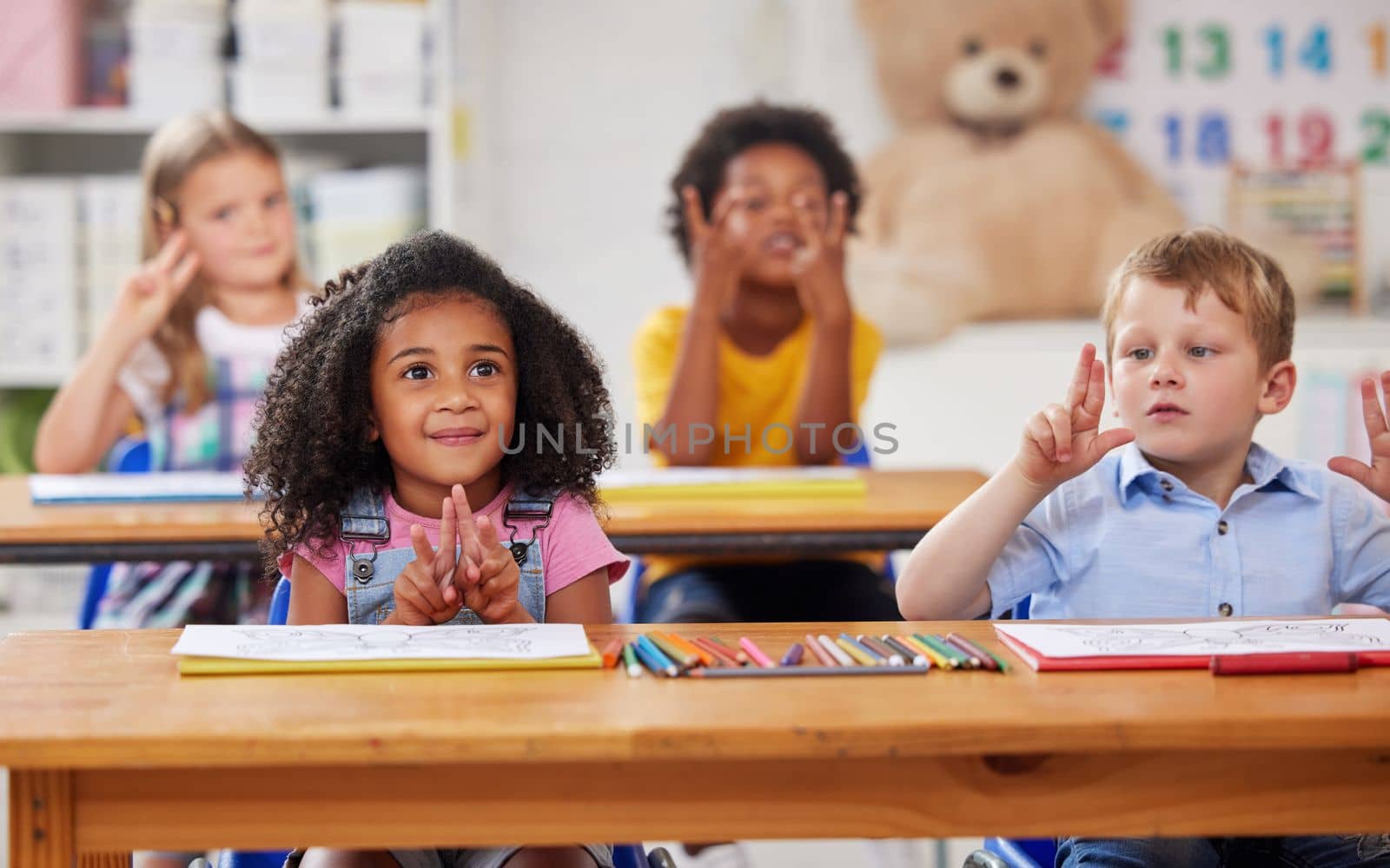 Who knows the answer. a group of preschool students sitting in a classroom