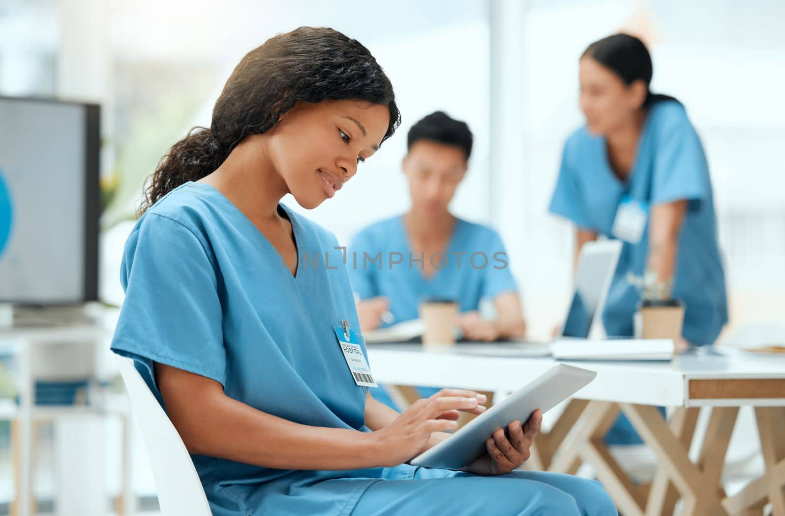 Maybe Ill find something on here. a young female doctor using a digital tablet at a hospital. by YuriArcurs
