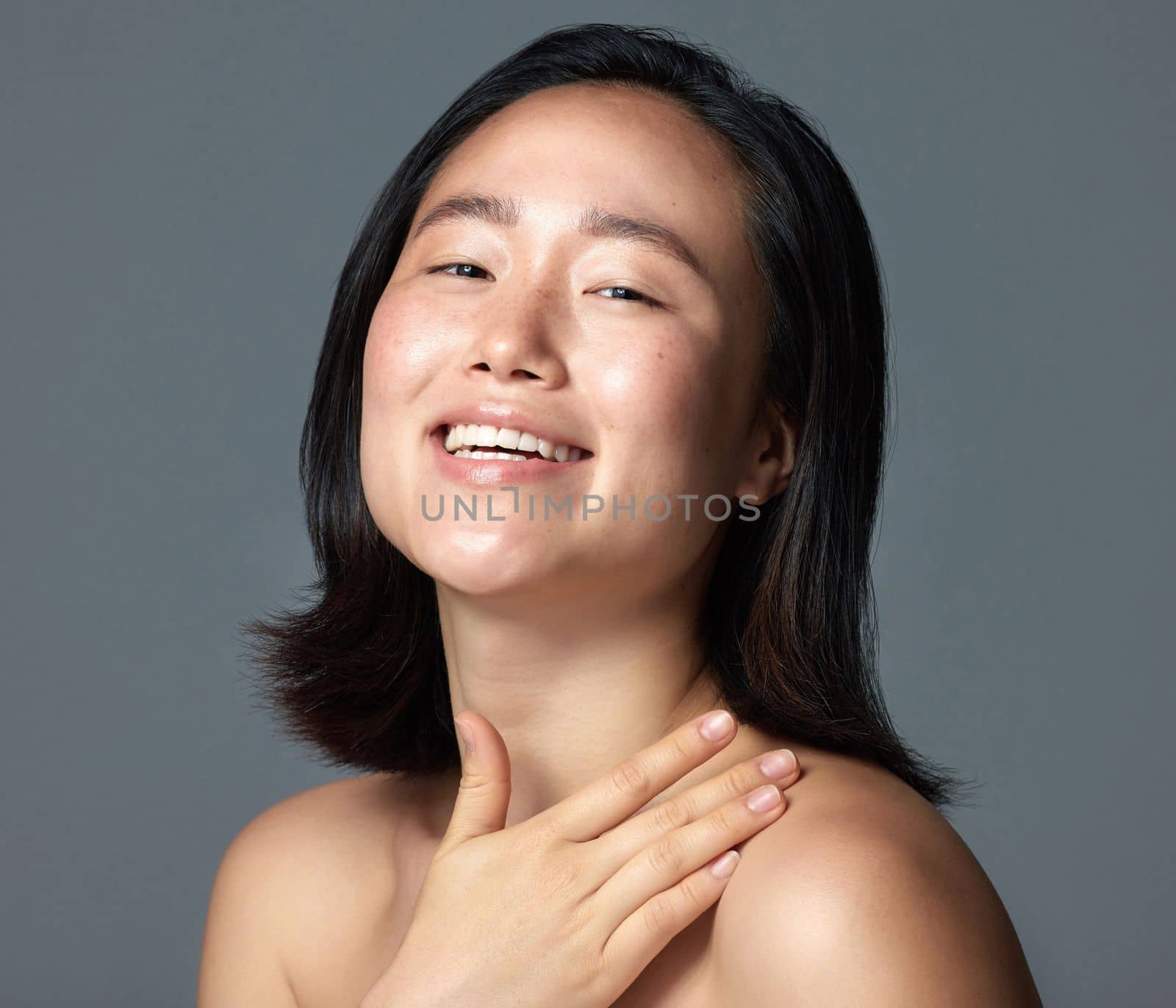 This lotion is by far the best Ive used. Studio shot of a beautiful young woman posing against a grey background