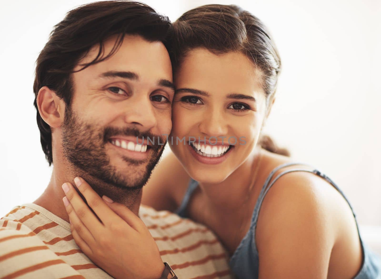 They compliment each other. an affectionate young couple bonding at home