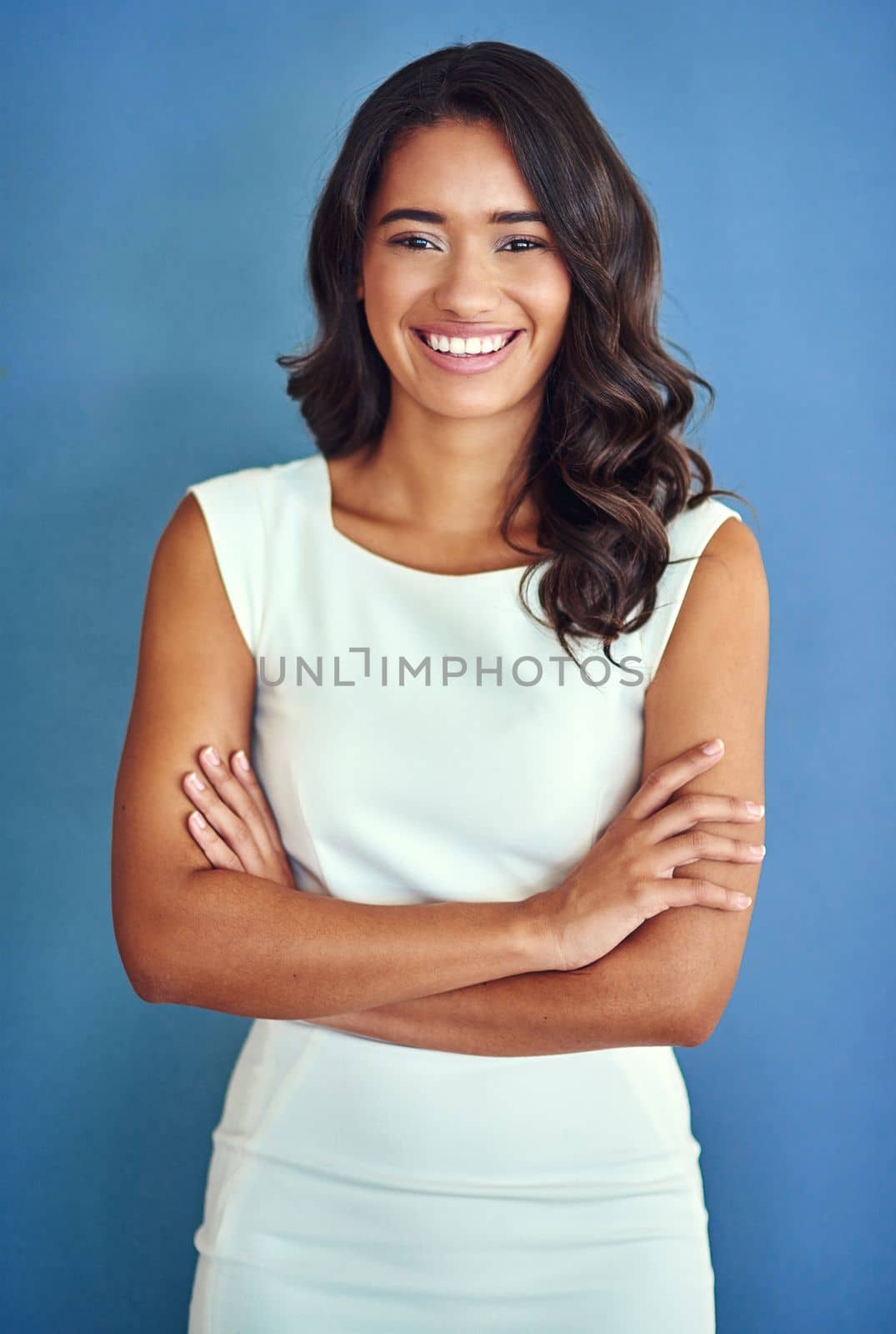 Its all about confidence. Studio portrait of a confident young woman posing against a blue background