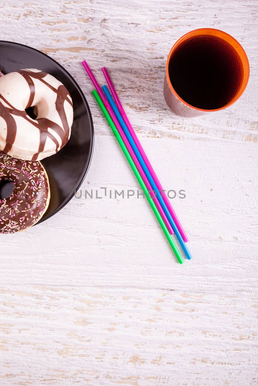 Different type of donuts on white wooden background by DCStudio