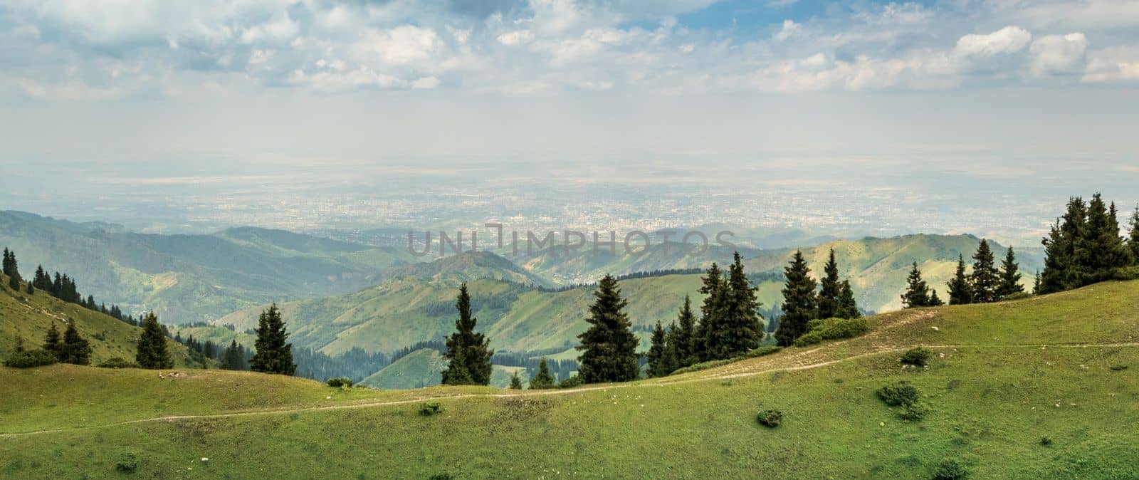Panoramic view of the city of Almaty from the tops of the Almaty mountains. Tourist natural places of Kazakhstan, copy space.