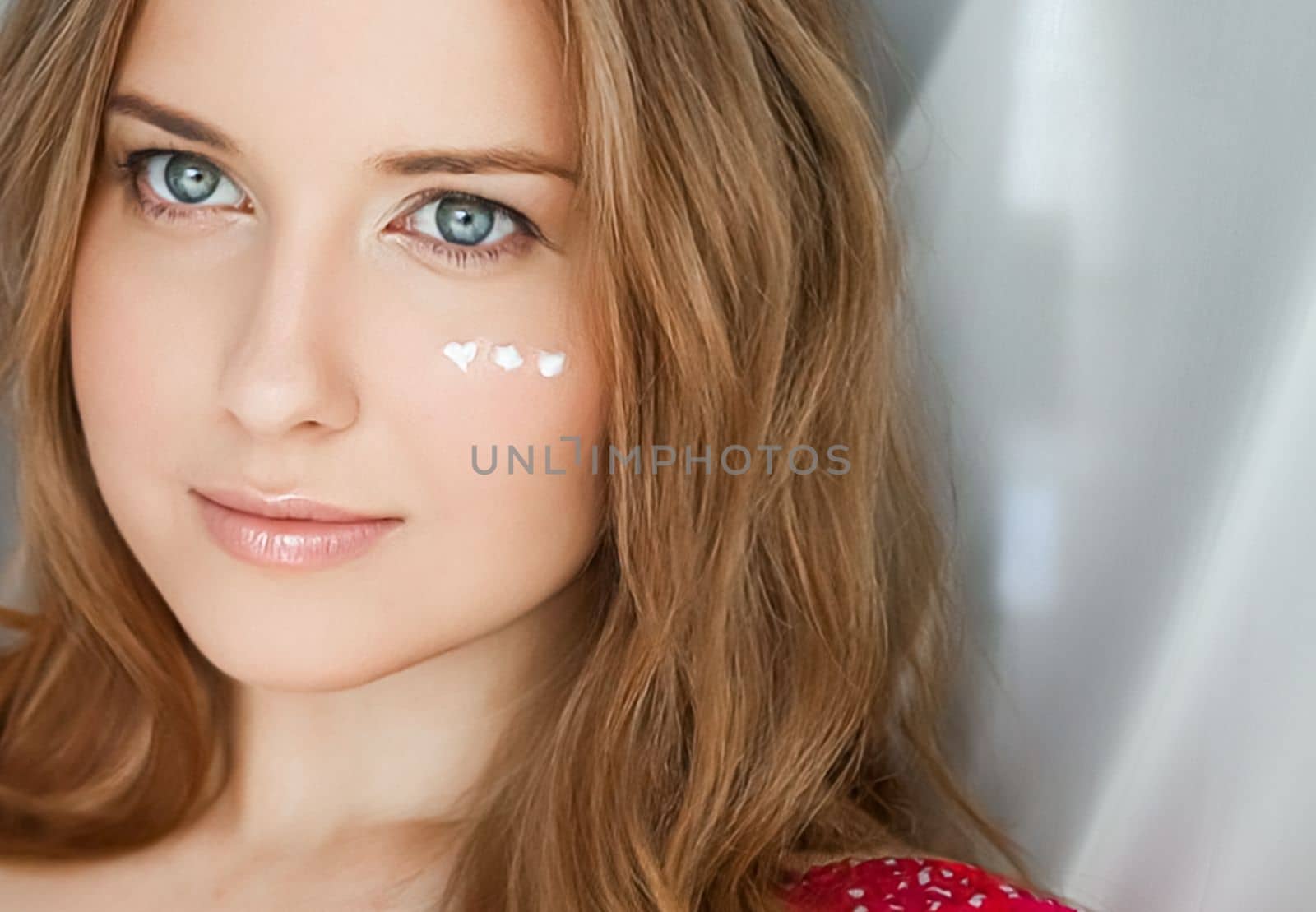 Beautiful woman with skincare cream on her face by Anneleven