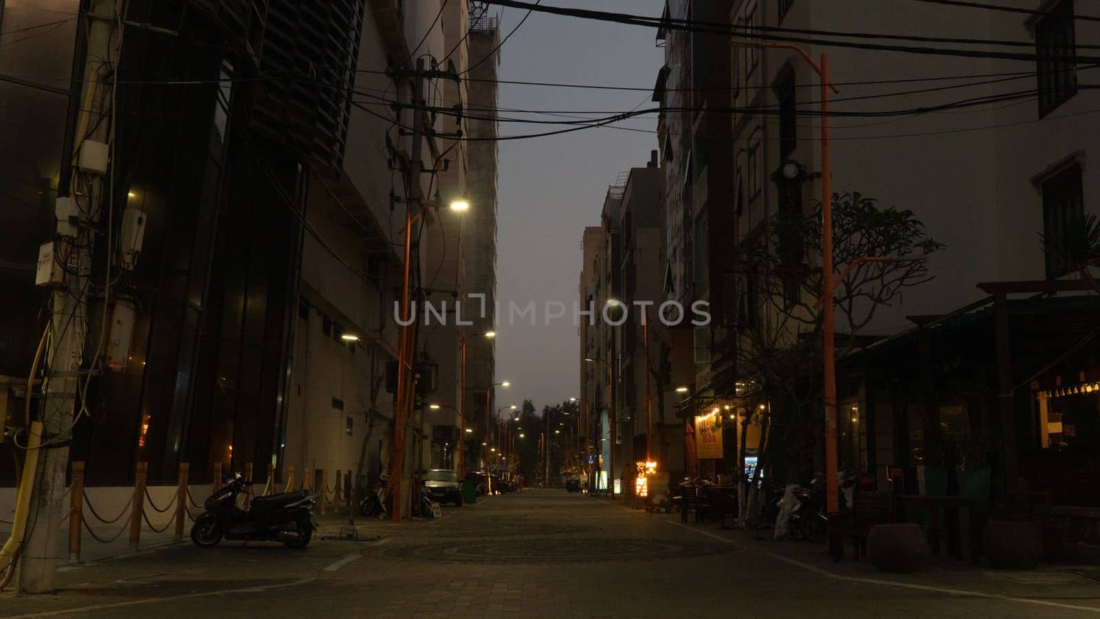 Asian street in the evening with street lamps and tangled electric wires. High quality photo