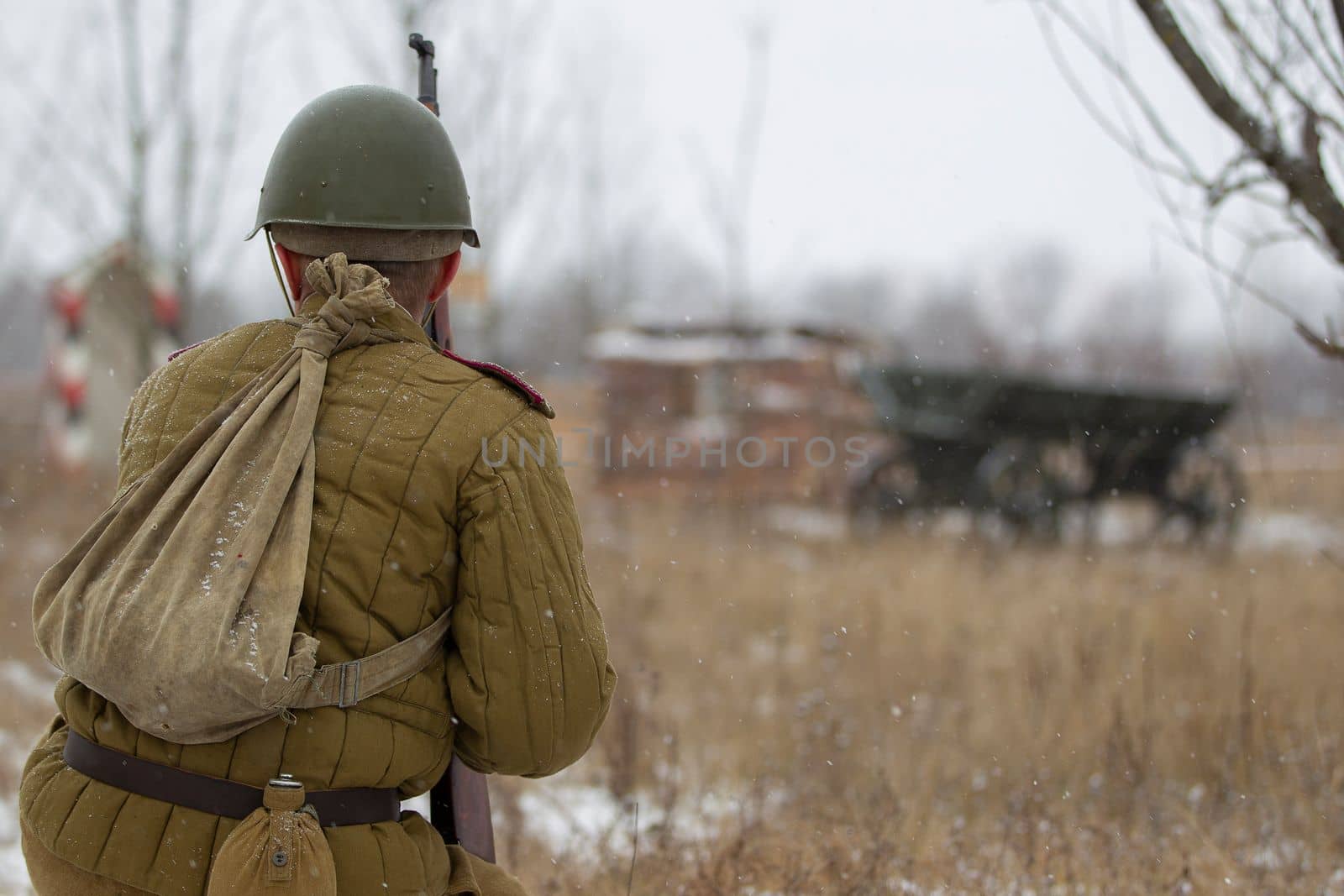 Belarus, Gomil, October 25, 2018 Reconstruction of hostilities. A World War II soldier stands with his back to the camera.
