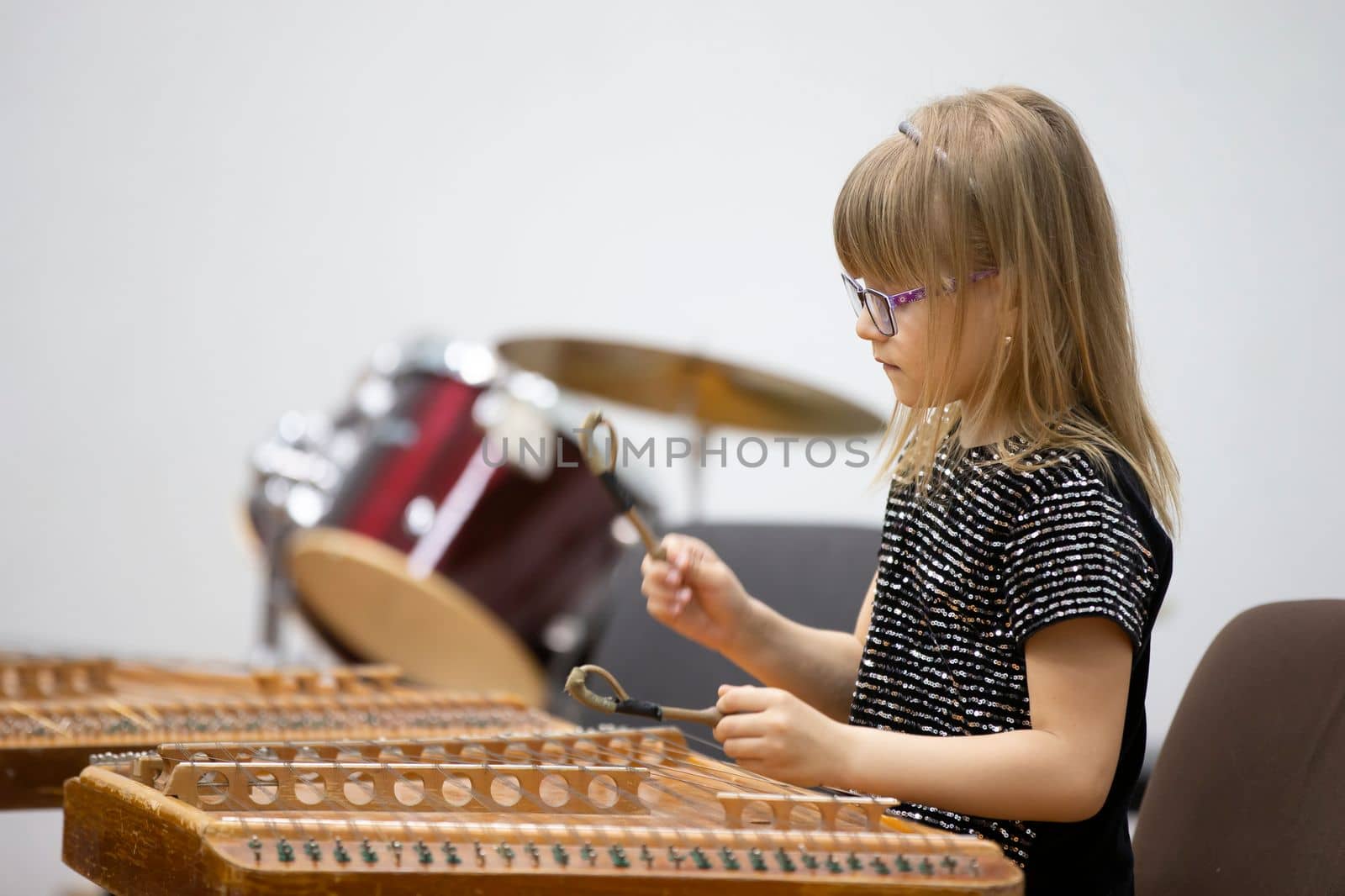 May 21, 2021 Belarus. city of Gomil. Holiday at the music school.The girl plays the ethnic instrument dulcimer by Sviatlana