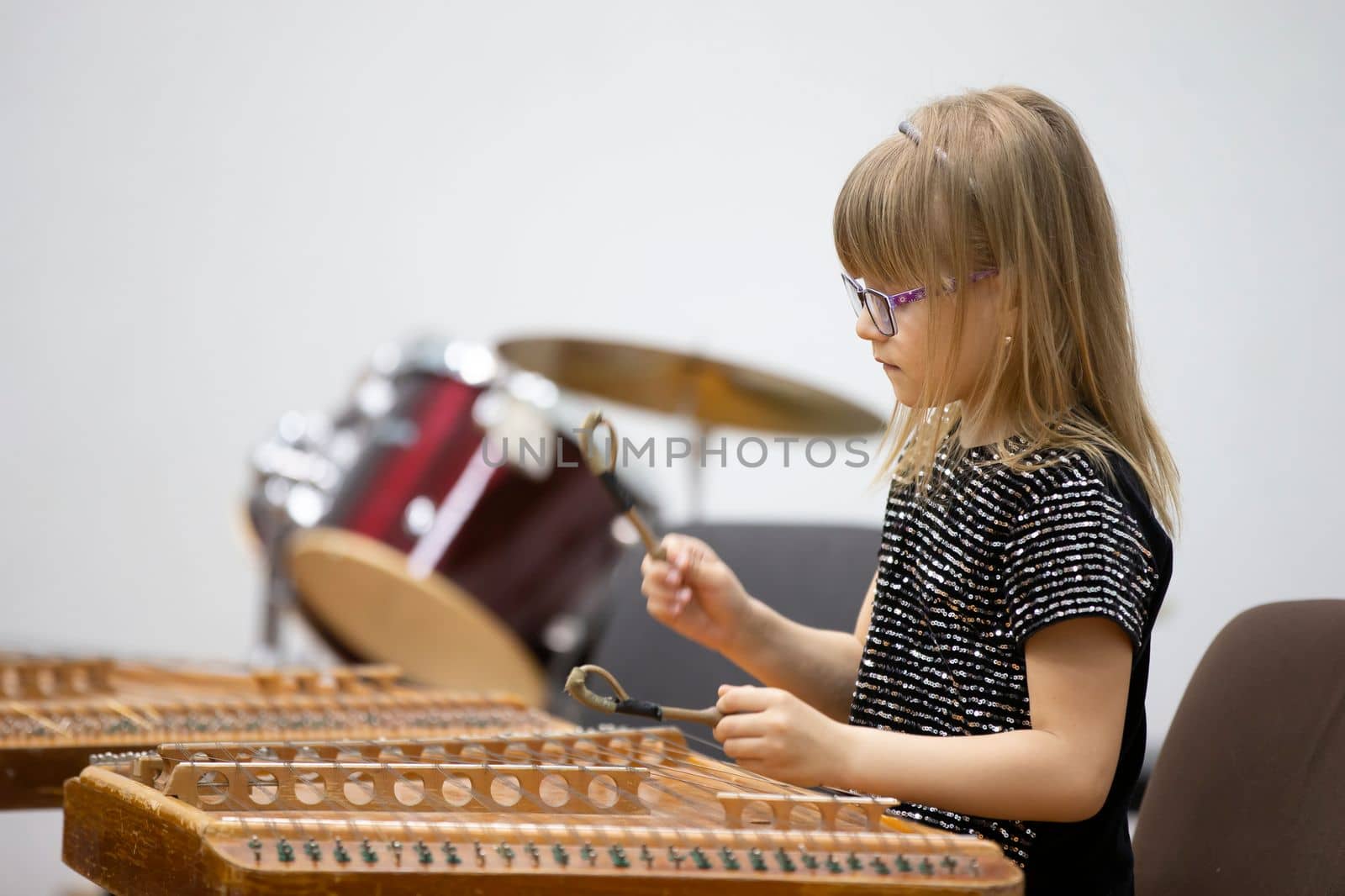 May 21, 2021 Belarus. city of Gomil. Holiday at the music school.The girl plays the ethnic instrument dulcimer