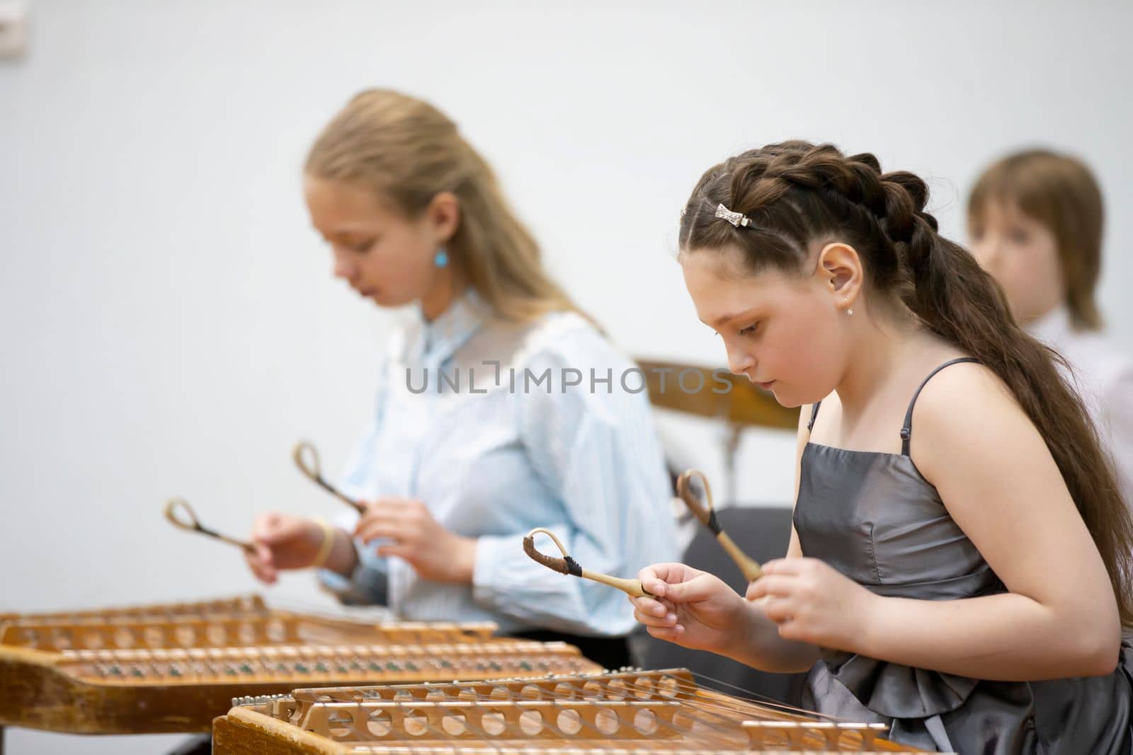 May 21, 2021 Belarus. city of Gomil. Holiday at the music school.The girl plays the ethnic instrument dulcimer