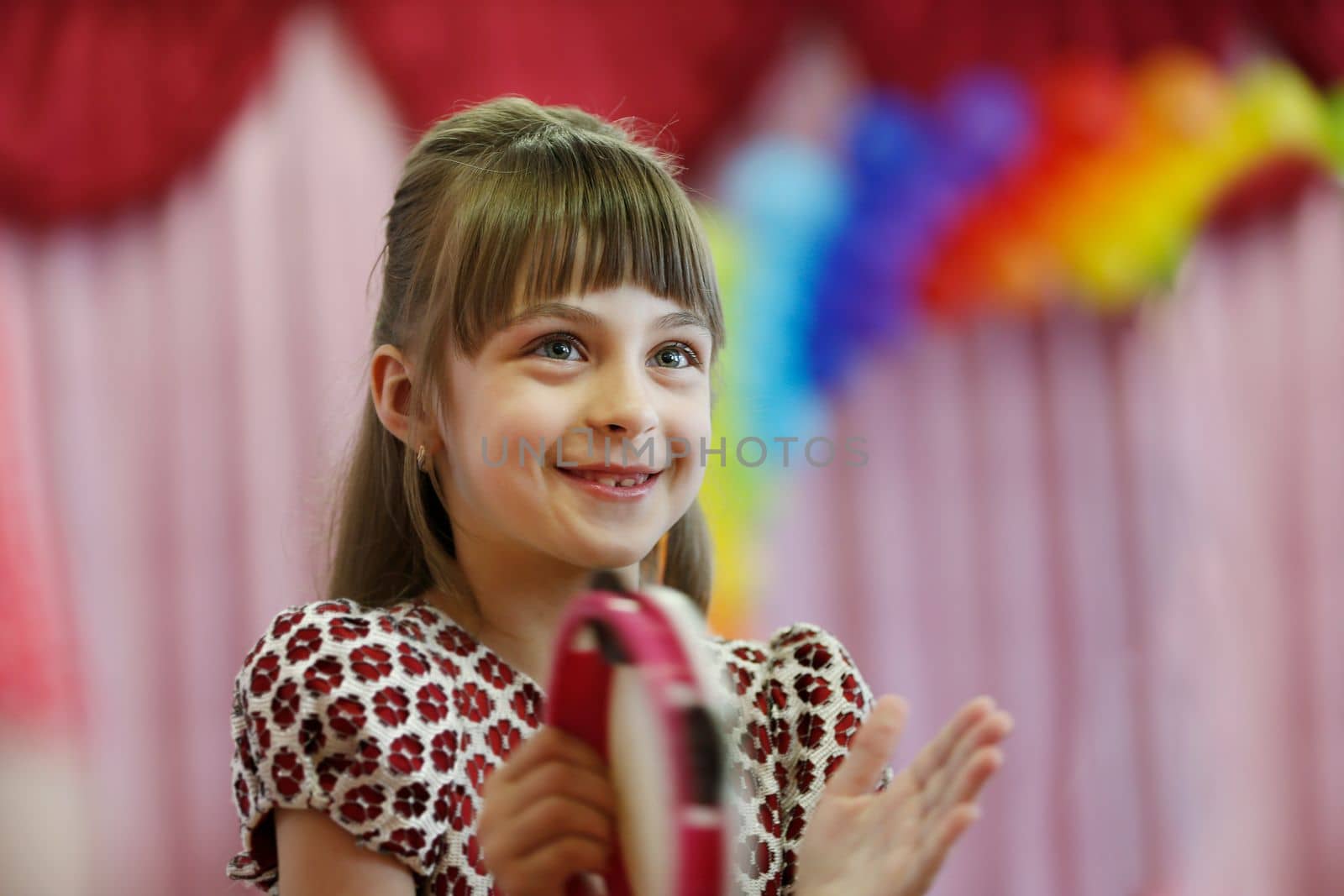 Belarus, city of Gomil, May 16, 2019. Morning in kindergarten.Portrait of a happy little girl at a children's party. by Sviatlana
