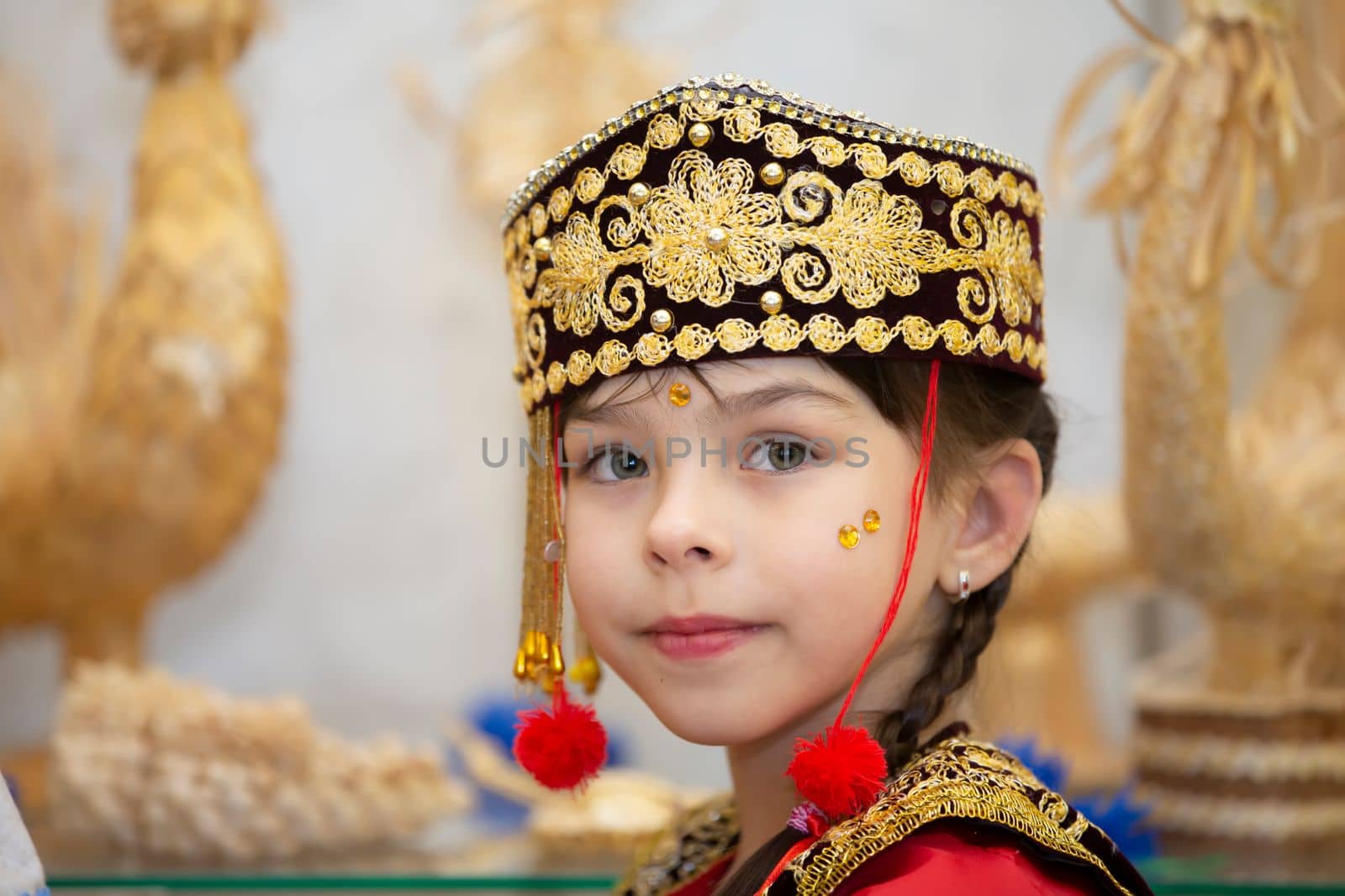 Belarus, city of Gomel, May 21, 2021 Children's holiday in the city. A little girl in the Uzbek national headdress.