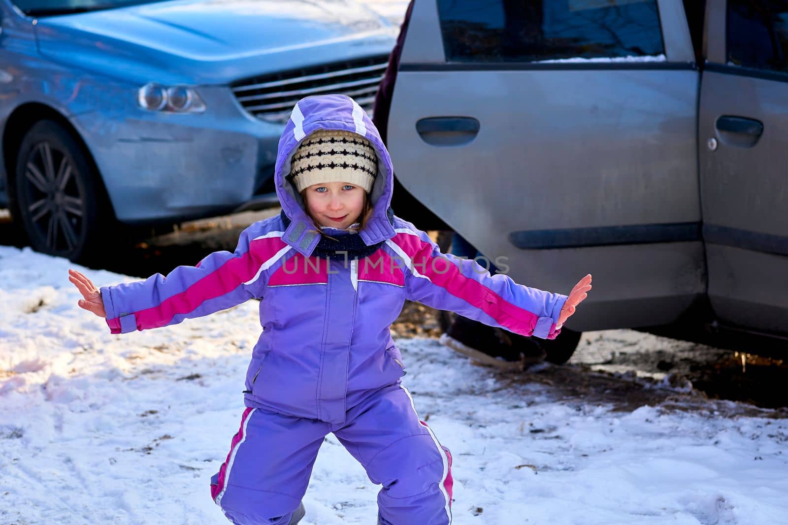 a young human being below the age of puberty or below the legal age of majority. A cute child in a lilac jumpsuit