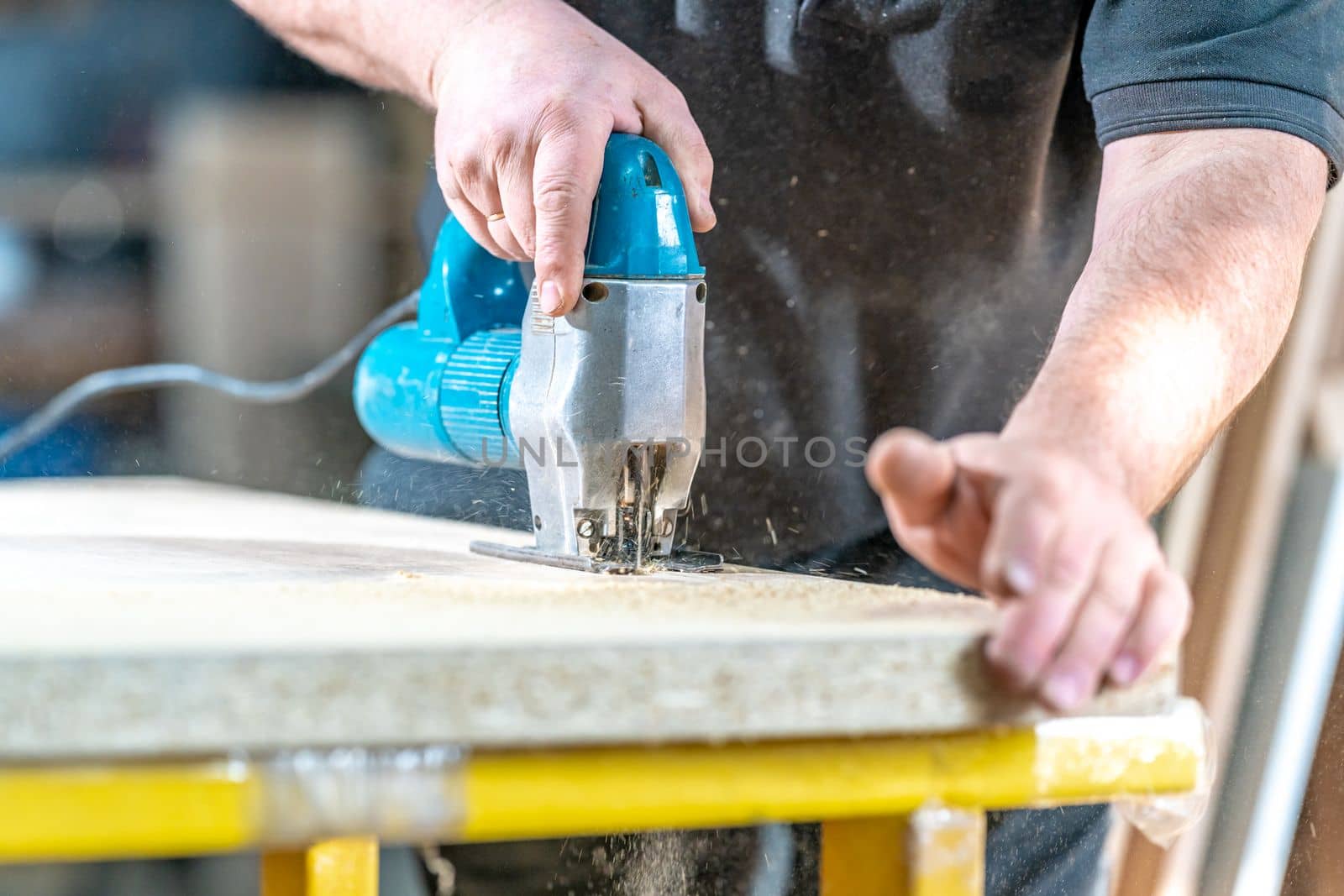 wood carving by hand with an electric saw. 