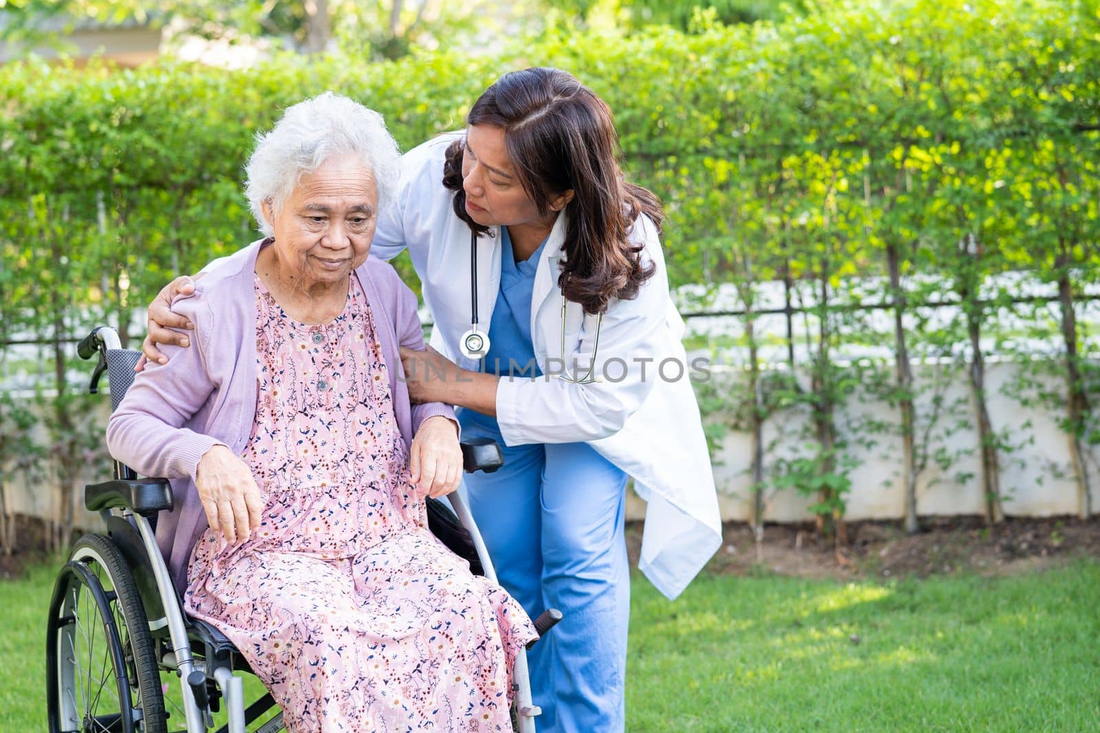caregiver help and care Asian senior woman patient sitting on wheelchair at nursing hospital ward, healthy strong medical concept.