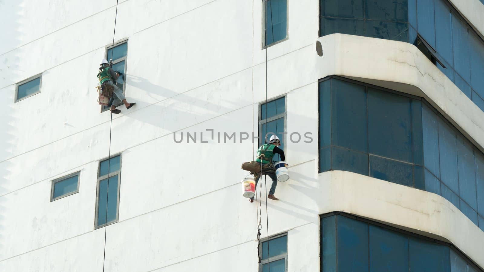 Industrial climbers paint high-rise walls and wash windows by voktybre